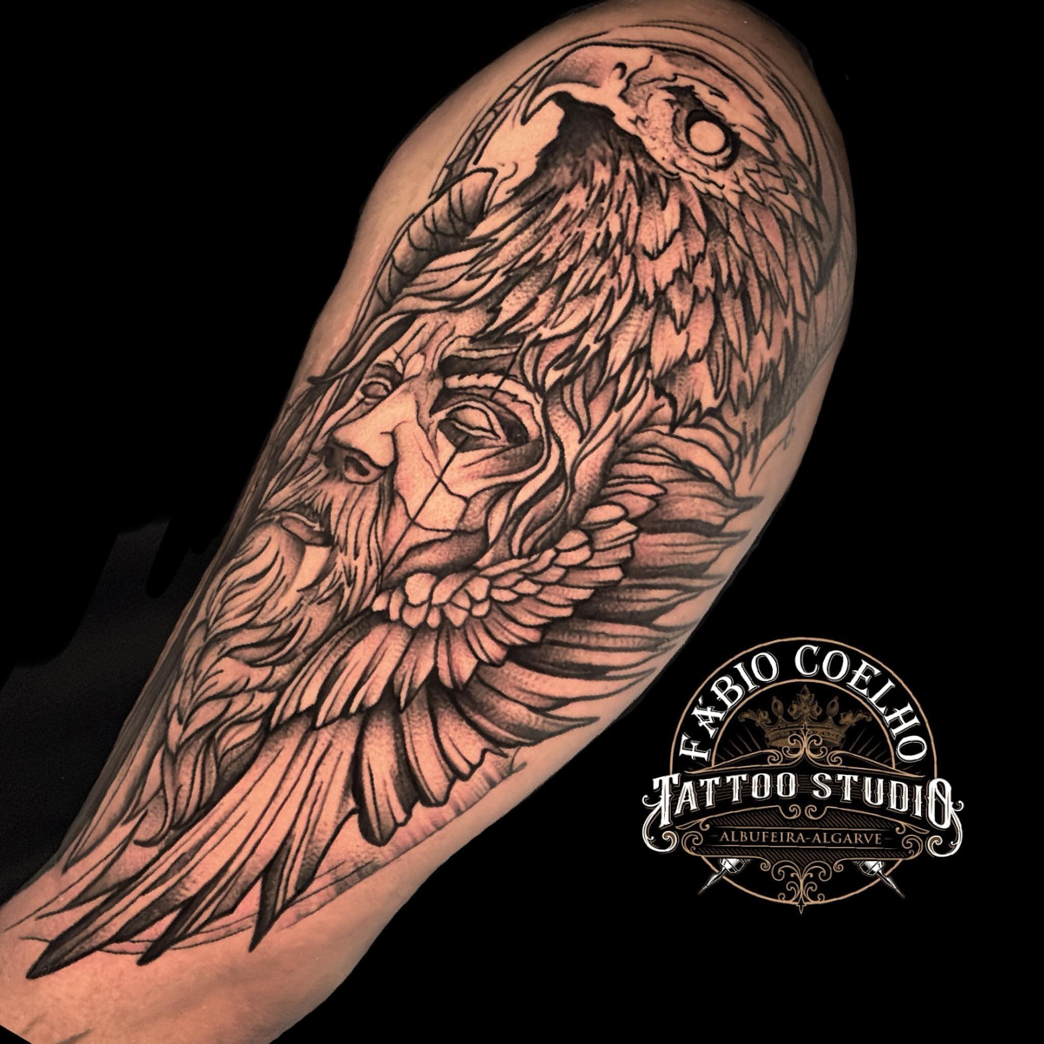 Black and grey owl on the upper arm
